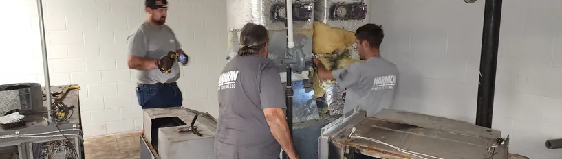 Harmon Heating & Cooling technicians servicing equipment